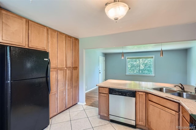 2497 S Race St, Denver, CO 80210 - kitchen with freestanding refrigerator, dishwasher, light tile patterned flooring, light countertops, and hanging light fixtures