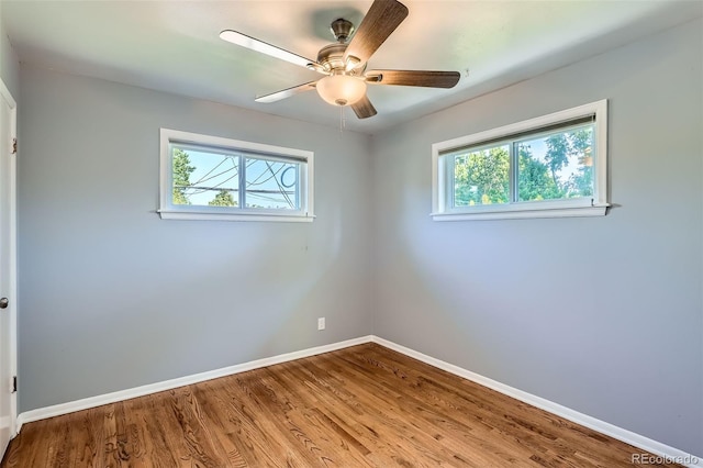 2497 S Race St, Denver, CO 80210 - empty room with healthy amount of natural light, wood finished floors, and ceiling fan