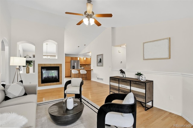 5193 Rustic Ave, Firestone, CO 80504 - living room featuring light wood-style flooring, a ceiling fan, high vaulted ceiling, and a fireplace