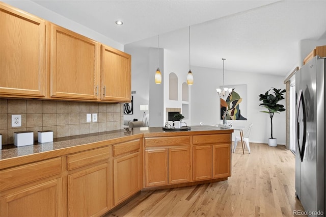 5193 Rustic Ave, Firestone, CO 80504 - kitchen featuring freestanding refrigerator, tile counters, tasteful backsplash, light wood finished floors, and a chandelier
