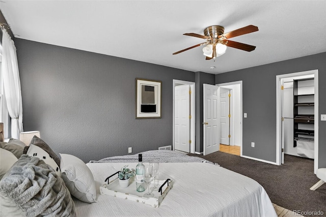 5193 Rustic Ave, Firestone, CO 80504 - bedroom with a walk in closet, ceiling fan, and a textured wall