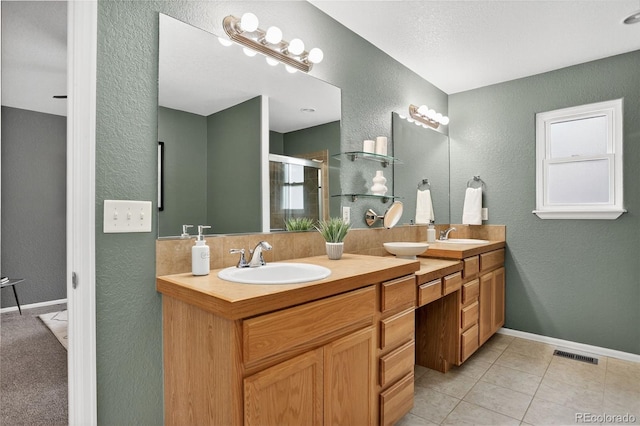 5193 Rustic Ave, Firestone, CO 80504 - full bath featuring a textured wall, double vanity, a shower stall, and tile patterned flooring