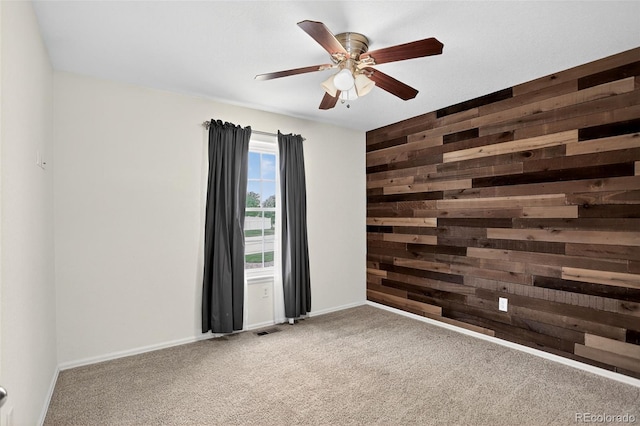 5193 Rustic Ave, Firestone, CO 80504 - carpeted spare room featuring wooden walls and ceiling fan
