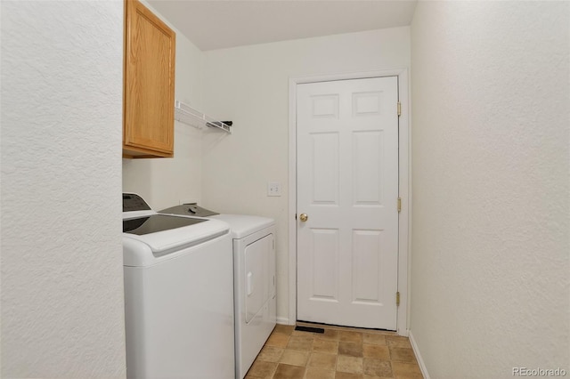 5193 Rustic Ave, Firestone, CO 80504 - washroom featuring cabinet space, washer and clothes dryer, stone finish flooring, and a textured wall