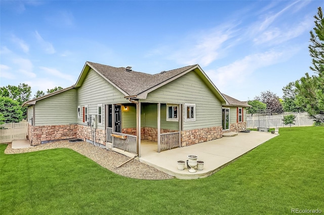5193 Rustic Ave, Firestone, CO 80504 - back of property with stone siding, a patio area, and a shingled roof