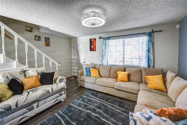 living room featuring a textured ceiling and dark wood-type flooring