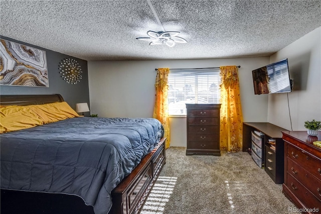 bedroom with carpet and a textured ceiling