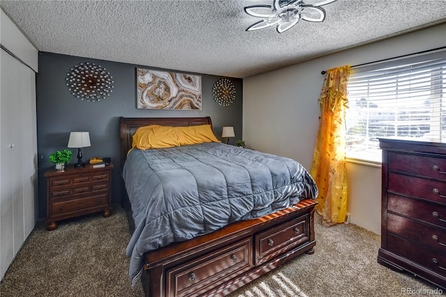 carpeted bedroom featuring a textured ceiling