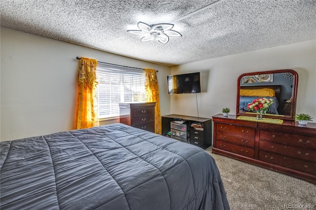 bedroom with carpet flooring and a textured ceiling