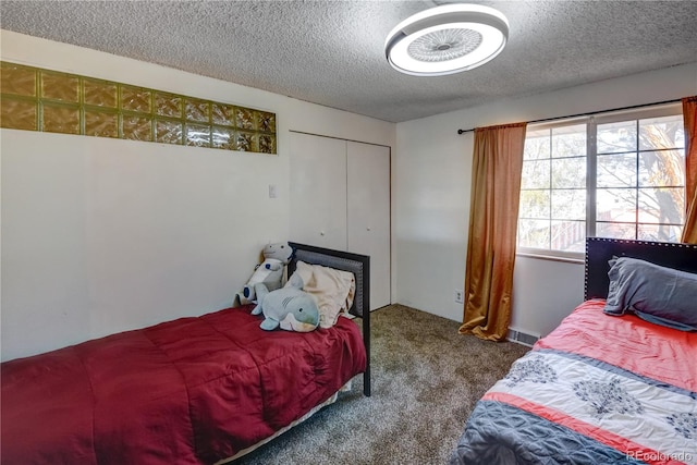 carpeted bedroom with a textured ceiling