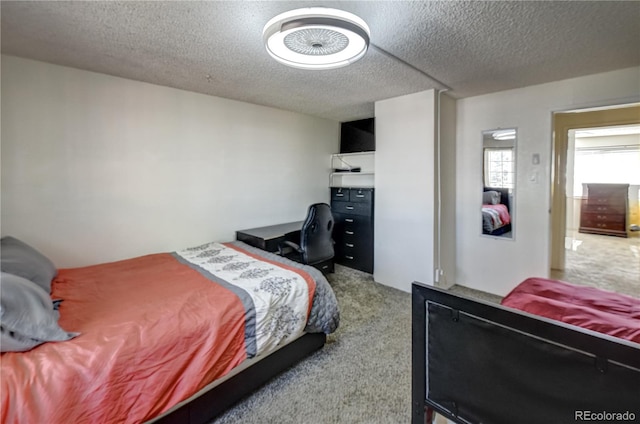 carpeted bedroom featuring a textured ceiling