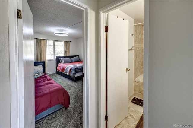 bedroom featuring a textured ceiling and carpet floors