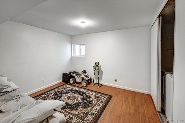 sitting room featuring washer / clothes dryer and light hardwood / wood-style floors