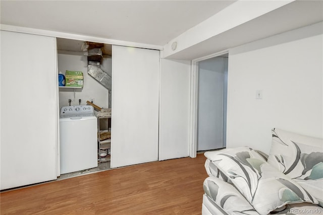 laundry room with light wood-type flooring and washer / clothes dryer