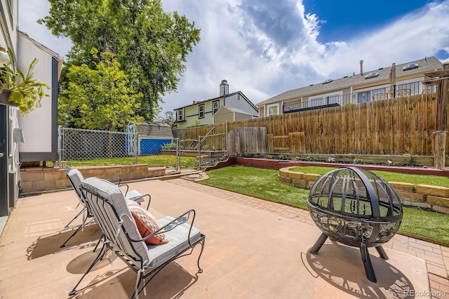 7953 S Garrison Way, Littleton, CO 80128 - fenced backyard featuring a patio area and a storage unit
