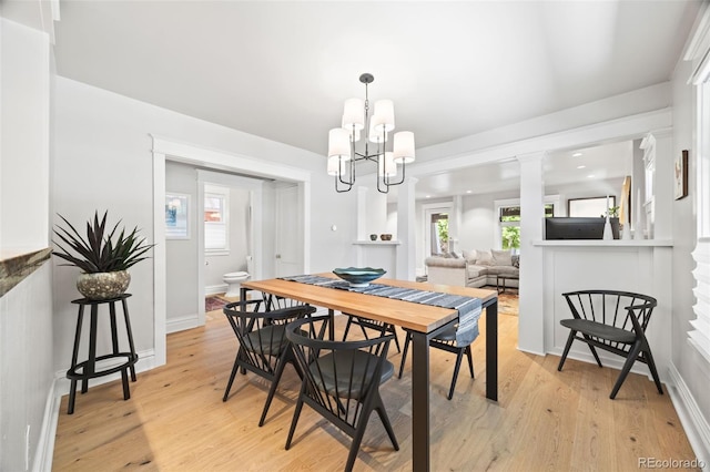 400 S Gilpin St, Denver, CO 80209 - dining room featuring a chandelier, light wood-style floors, and decorative columns