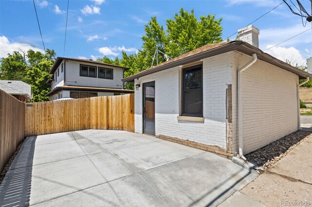 400 S Gilpin St, Denver, CO 80209 - back of property with brick siding, a chimney, and a patio