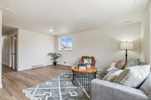 living area with wood finished floors and baseboards