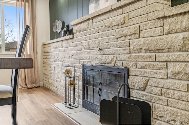 detailed view of wood finished floors and a fireplace