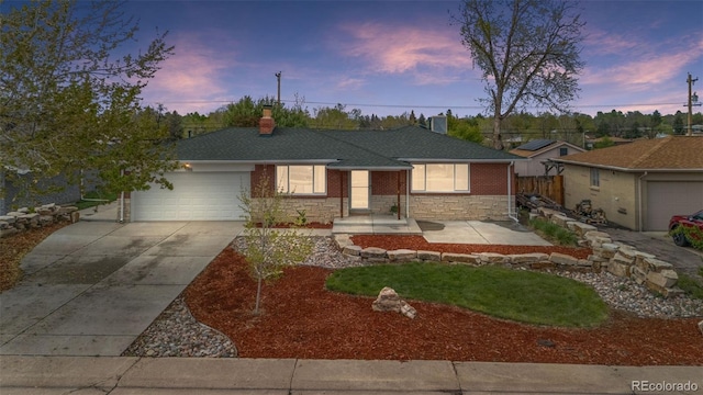 ranch-style house featuring driveway, a garage, fence, a chimney, and stone siding