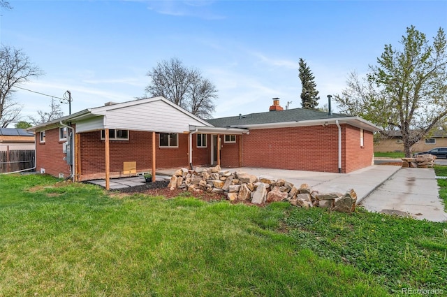 1155 W 4th Ave, Broomfield, CO 80020 - rear view of property featuring brick siding, a patio, and a chimney