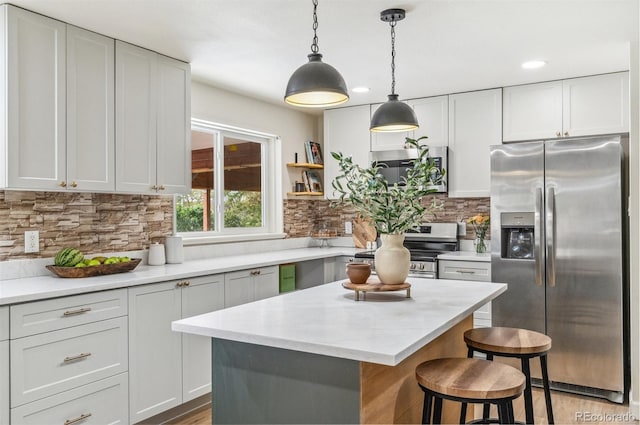 1155 W 4th Ave, Broomfield, CO 80020 - kitchen with stainless steel appliances, a kitchen bar, decorative backsplash, decorative light fixtures, and recessed lighting