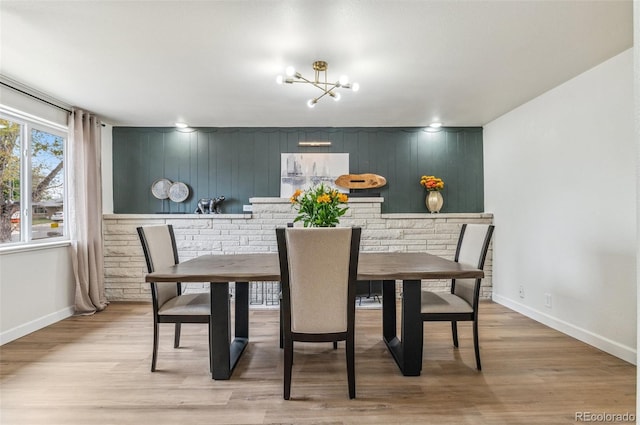 1155 W 4th Ave, Broomfield, CO 80020 - dining area featuring baseboards, light wood-style floors, and a chandelier