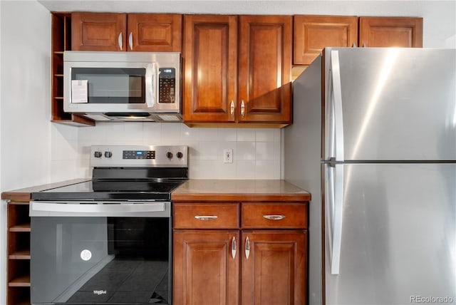 kitchen featuring open shelves, tasteful backsplash, brown cabinets, and stainless steel appliances
