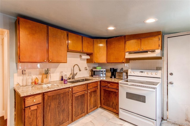 kitchen with tasteful backsplash, light stone countertops, sink, and electric range