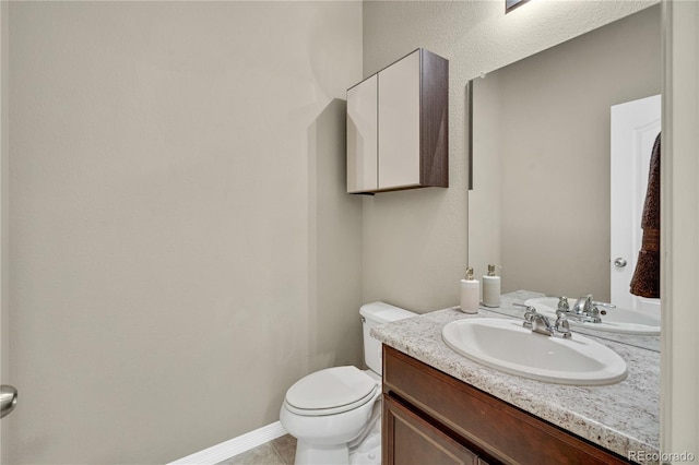 bathroom featuring tile patterned floors, vanity, and toilet