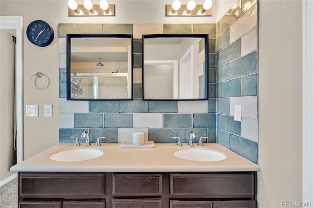 bathroom with an enclosed shower, vanity, and backsplash