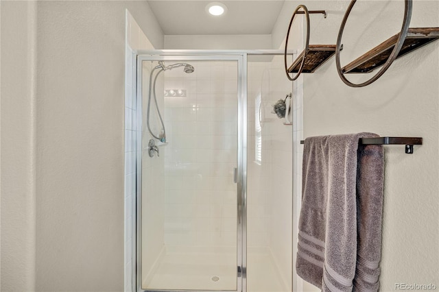 bathroom with a shower with door