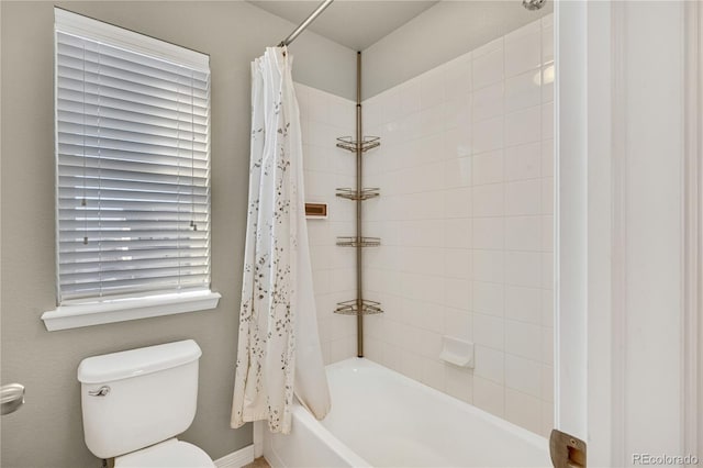 bathroom featuring shower / bath combination with curtain and toilet