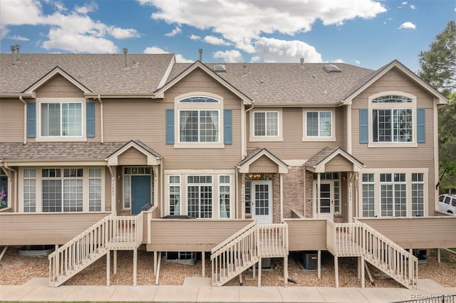 5555 E Briarwood Ave Unit 1404, Centennial, CO 80122 - rear view of house featuring stairs, roof with shingles, and a wooden deck