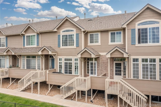 5555 E Briarwood Ave Unit 1404, Centennial, CO 80122 - view of front of home with stairway, a shingled roof, and a deck