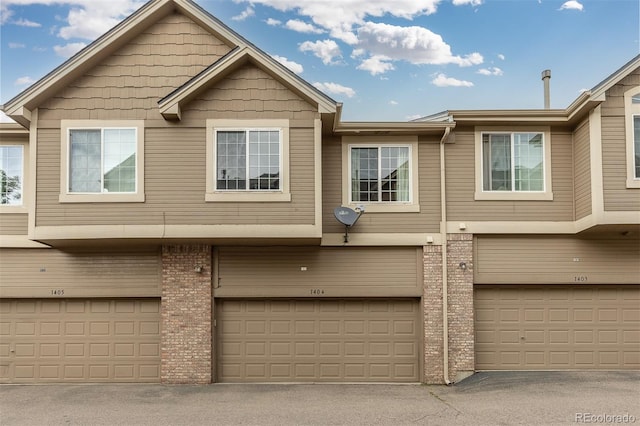 5555 E Briarwood Ave Unit 1404, Centennial, CO 80122 - view of front facade featuring brick siding and a garage