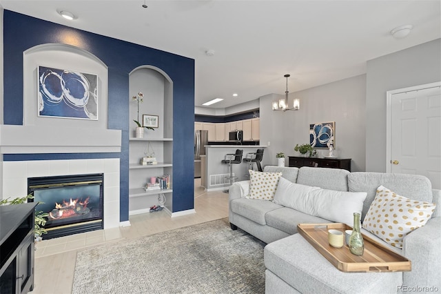 5555 E Briarwood Ave Unit 1404, Centennial, CO 80122 - living room with a chandelier, light wood-style floors, a fireplace, and recessed lighting