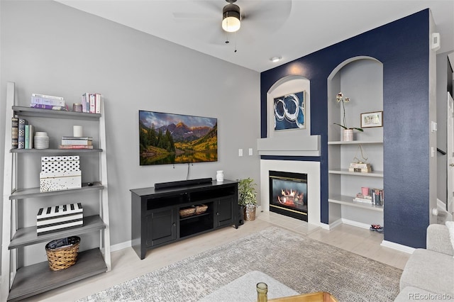 5555 E Briarwood Ave Unit 1404, Centennial, CO 80122 - living room featuring a fireplace, a ceiling fan, built in features, and wood finished floors
