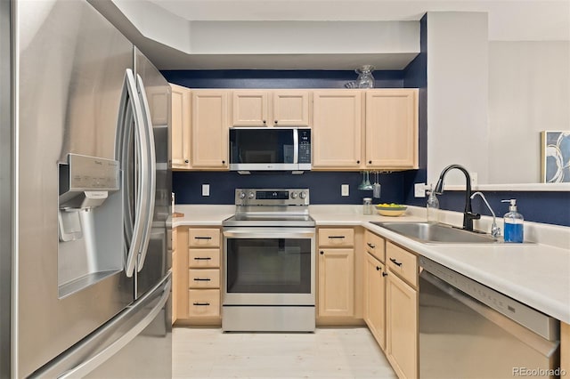 5555 E Briarwood Ave Unit 1404, Centennial, CO 80122 - kitchen featuring appliances with stainless steel finishes, light brown cabinetry, a sink, light countertops, and light wood finished floors