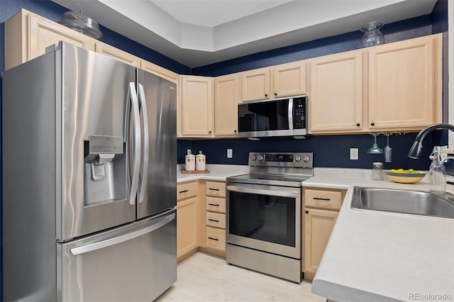 5555 E Briarwood Ave Unit 1404, Centennial, CO 80122 - kitchen with appliances with stainless steel finishes, light brown cabinets, a sink, and light countertops