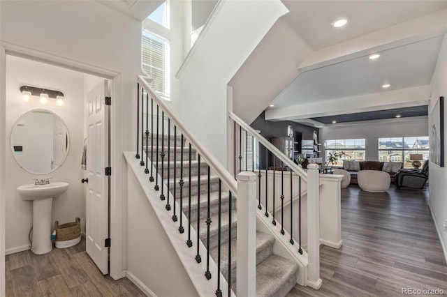 stairway with recessed lighting, wood finished floors, and baseboards