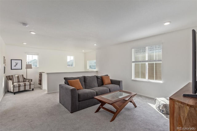 carpeted living area featuring recessed lighting