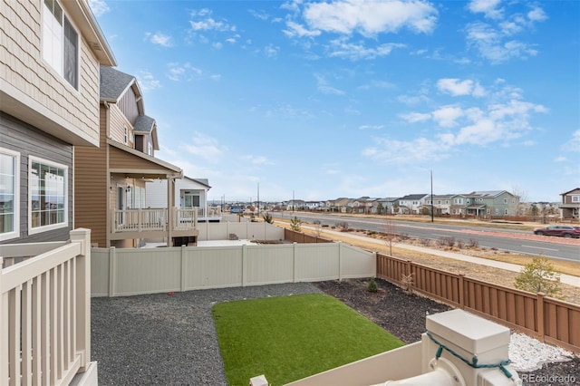 view of yard featuring a residential view and a fenced backyard