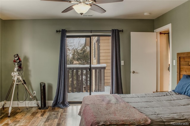 bedroom with access to exterior, visible vents, ceiling fan, baseboards, and wood finished floors