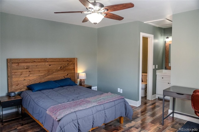 bedroom with a ceiling fan, ensuite bath, wood finished floors, and baseboards