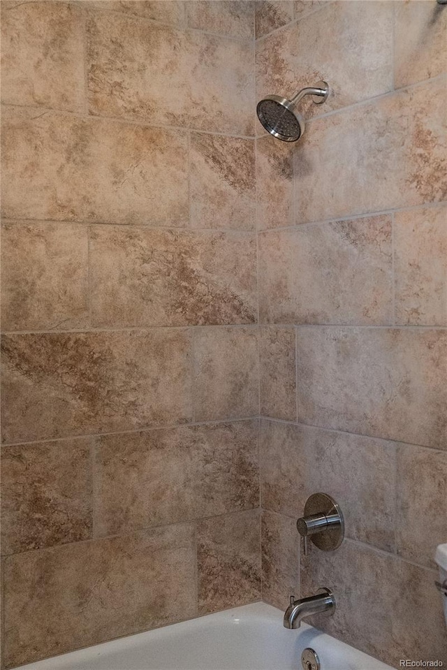 room details featuring shower / bathtub combination