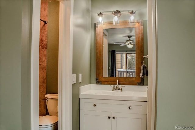 bathroom with toilet, ceiling fan, and vanity