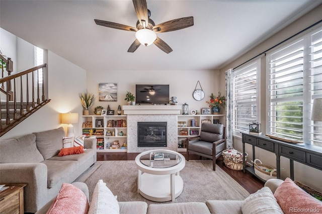 21502 E Idyllwilde Dr, Parker, CO 80138 - living area with wood finished floors, ceiling fan, a fireplace, and stairway