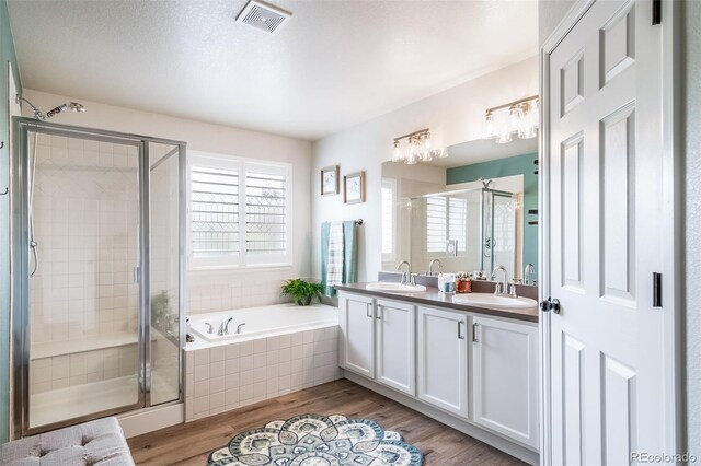 21502 E Idyllwilde Dr, Parker, CO 80138 - full bathroom featuring a shower stall, a garden tub, double vanity, and wood finished floors