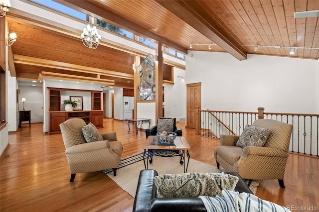 78 Fairway Ln, Littleton, CO 80123 - living room featuring a chandelier, decorative columns, wood ceiling, and wood finished floors